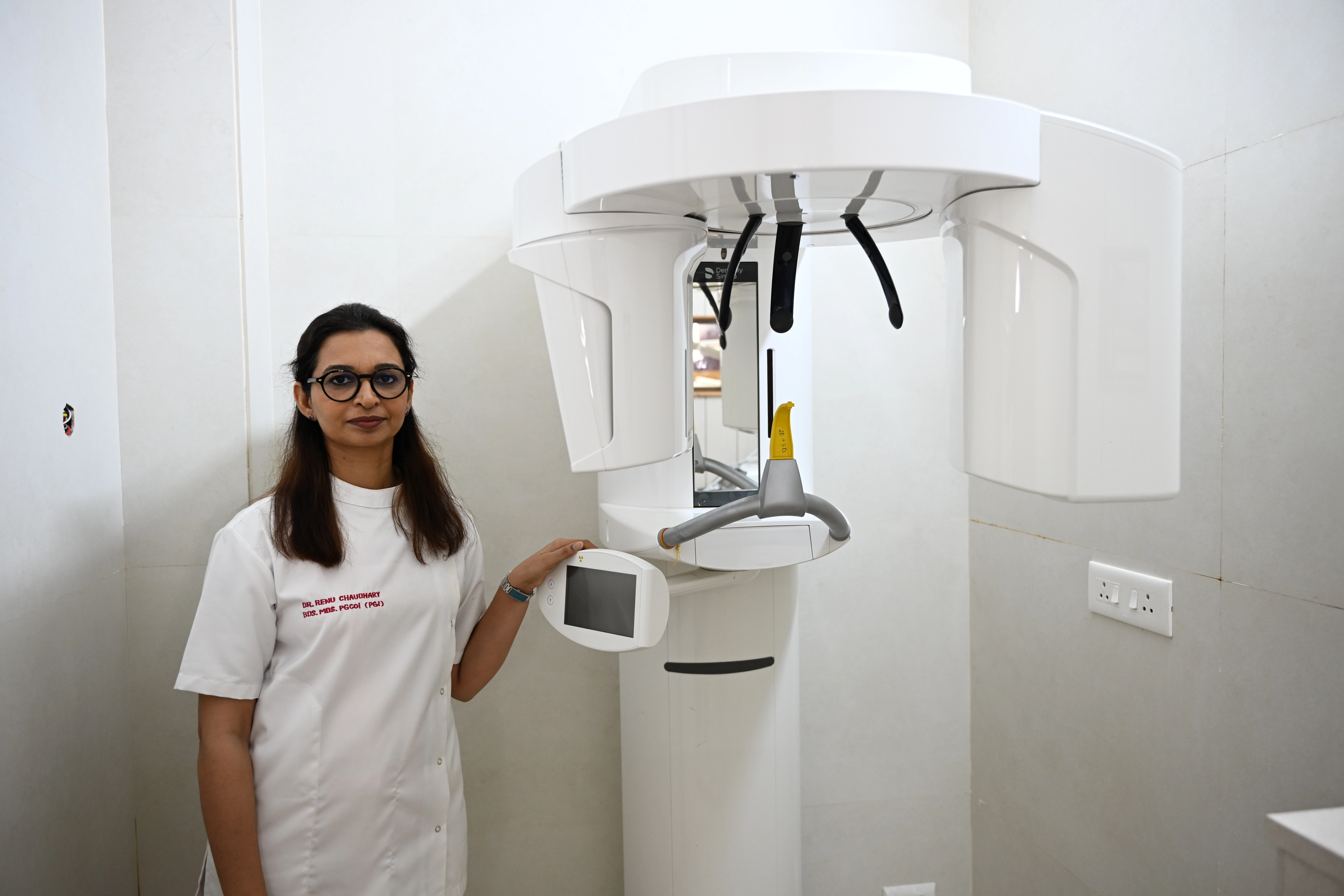 Patient receiving root canal treatment under a dental microscope at Renu Dental